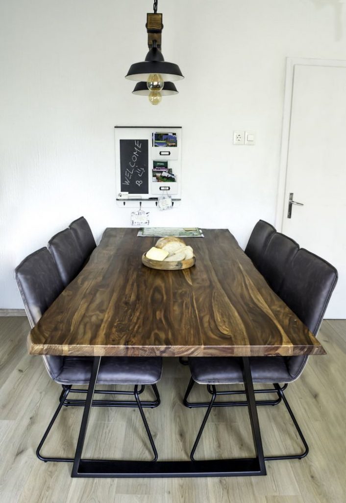 A custom handmade wooden table for six made of walnut tree.