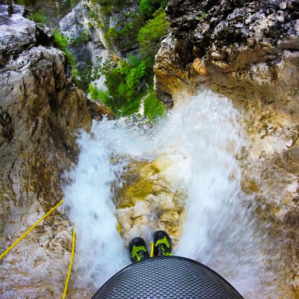 A guide standing on top of Parabola waterfall looking down to the bottom.